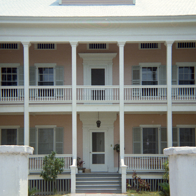 Elegant two-storey pink house with white trim. Key West.