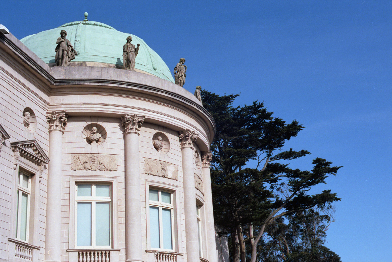 The Rotunda, on the west elevation of the California Palace of the Legion of Honor, is decorated with six classical statues standing on the abacus of the green-oxidized bronze dome. This side of the building faces the Ocean.