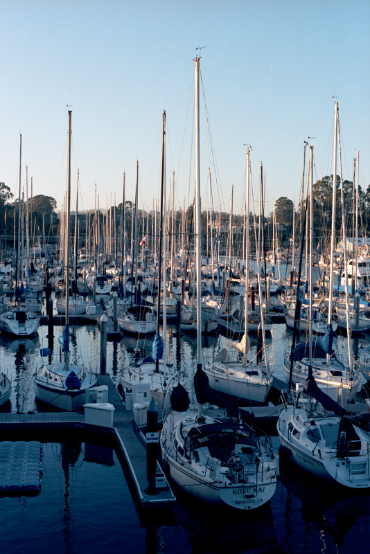 At the Santa Cruz Yacht Harbor looking toward the north; shadows moving in as night approaches. All boats appear to be secured for the evening.